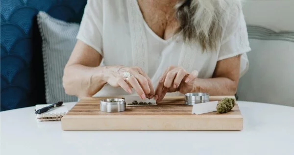 old woman rolling a joint